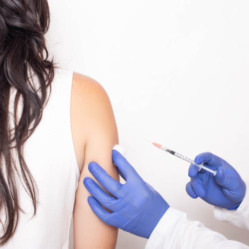 Allergist doctor injects against allergies to a young girl, a medical. Allergen-specific immunotherapy